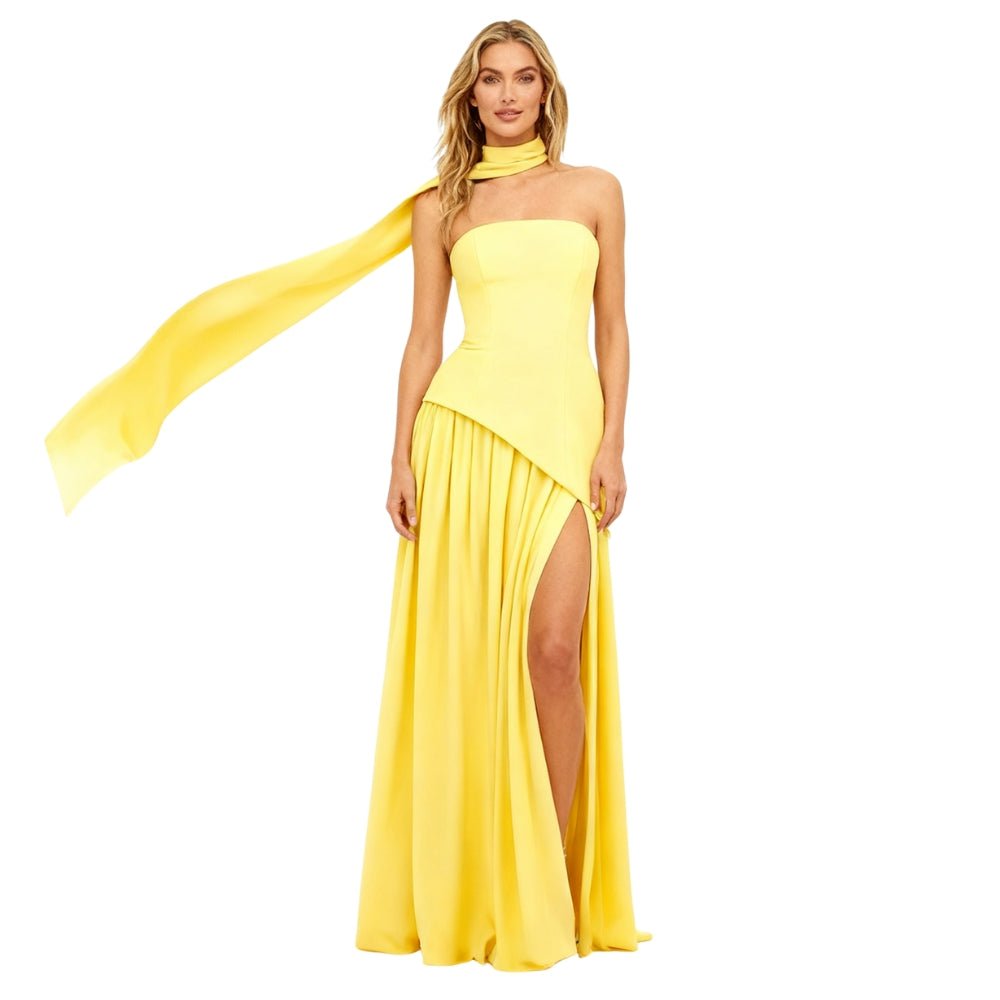 Yellow Kouvr evening gown with a slit on a white background