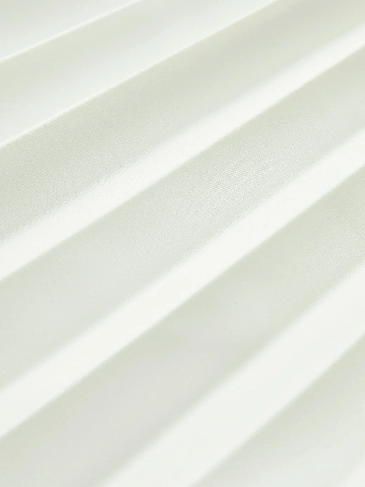 architectural," "sculptural," "asymmetrical," "bonded crepe," and "sunray pleats