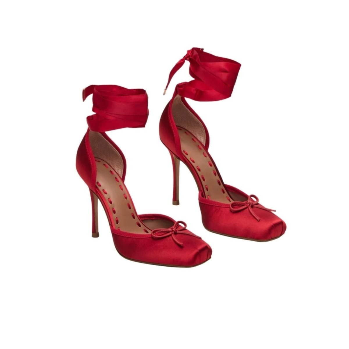 Red kouvr high-heeled shoes with ankle straps and bow details on a white background