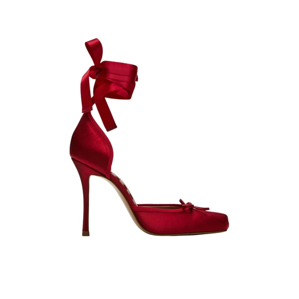 Red kouvr high-heeled shoe with a large bow on a white background