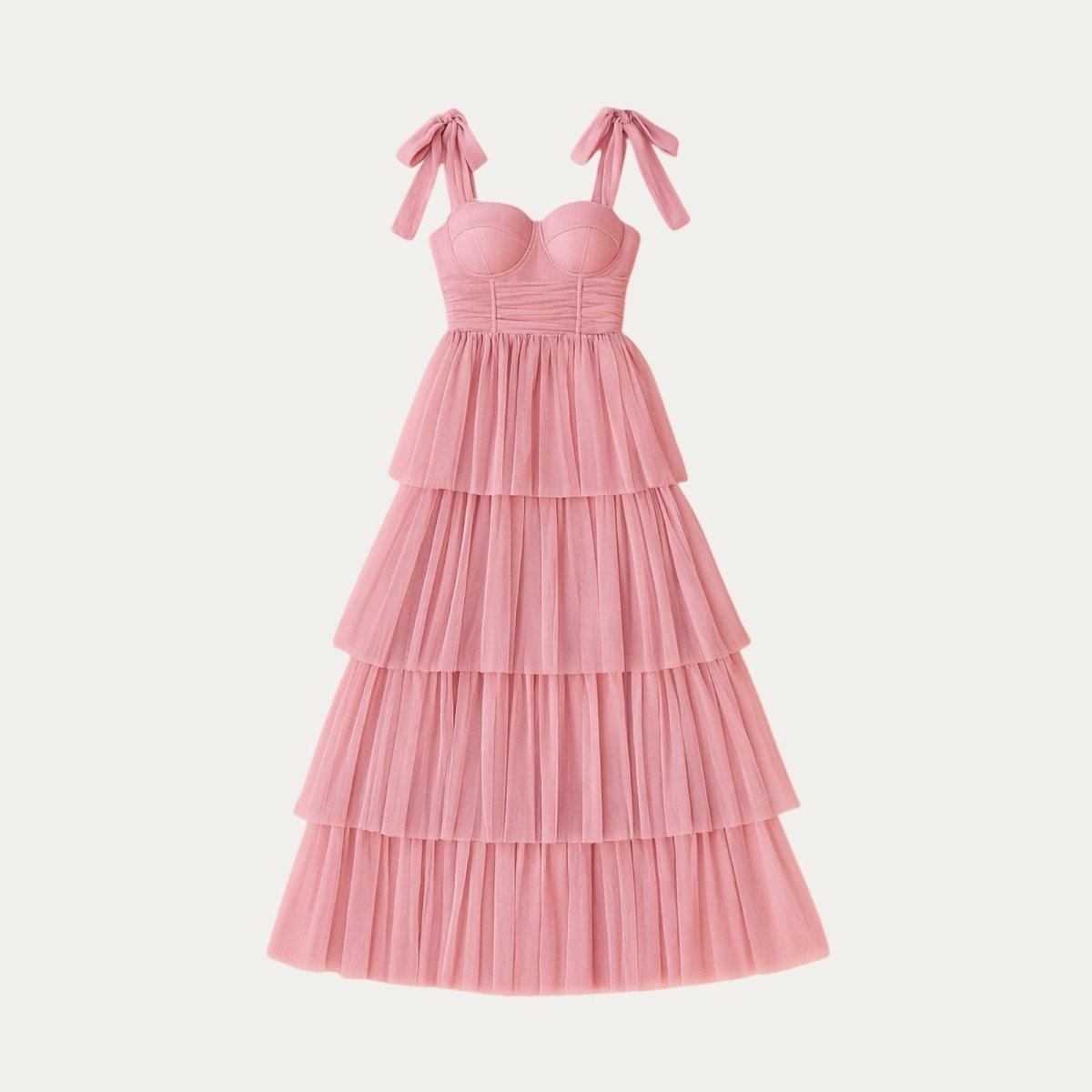 Pink Kouvr tiered dress with bow straps on a light gray background