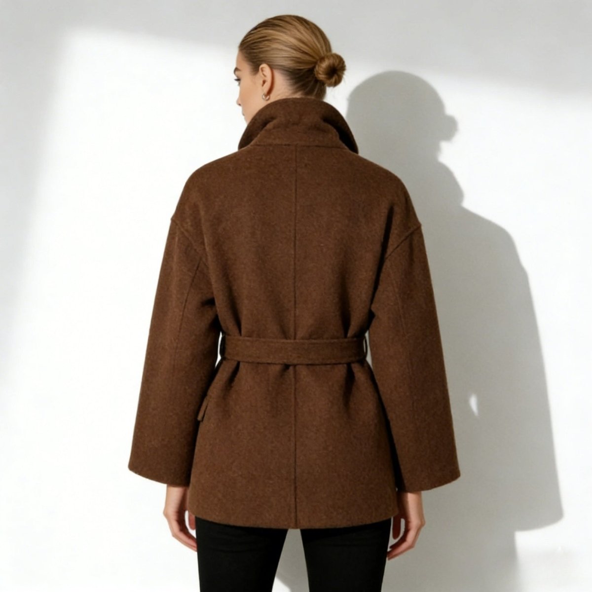 Back view of the Kouvr Fashion short brown wool coat, highlighting the belt and minimalist construction.