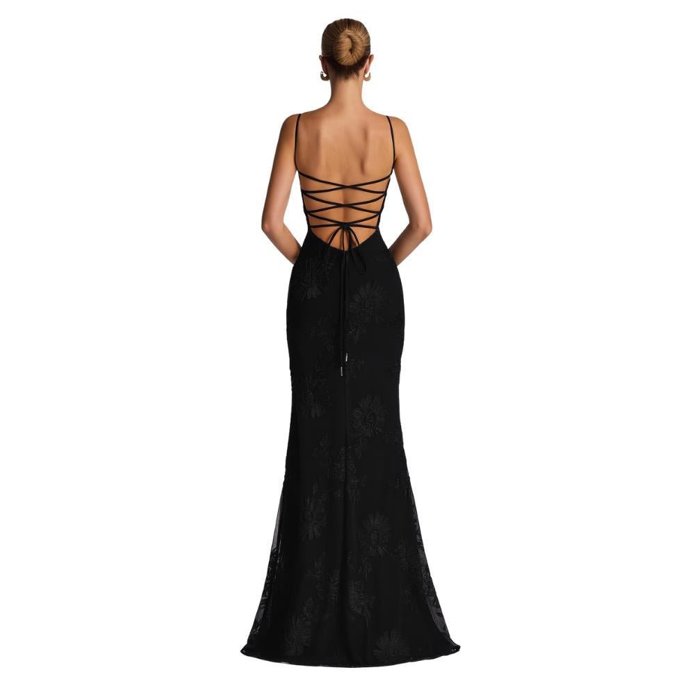 Black kouvr evening gown with open back on a white background