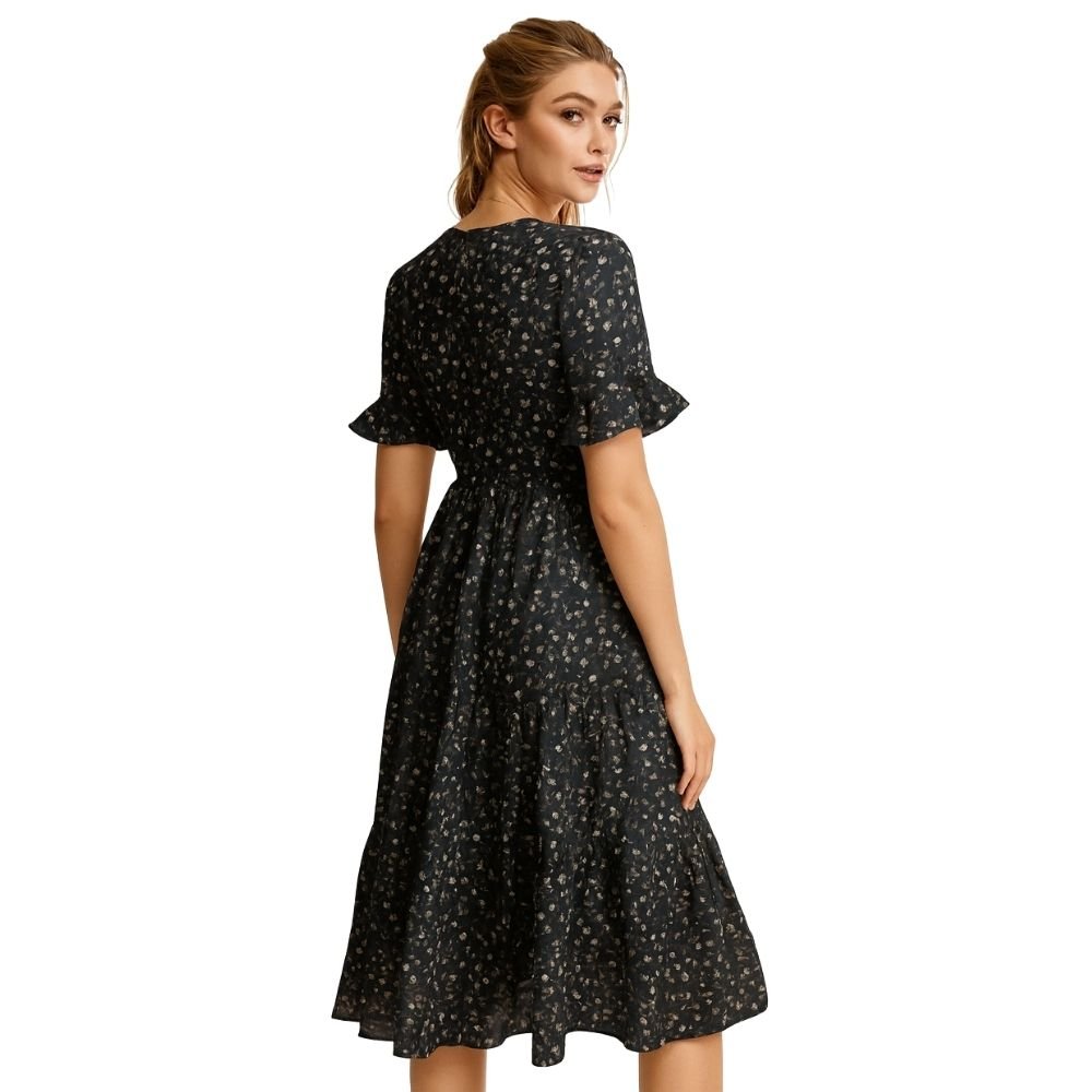 Woman wearing a black kouvr  floral dress on a white background