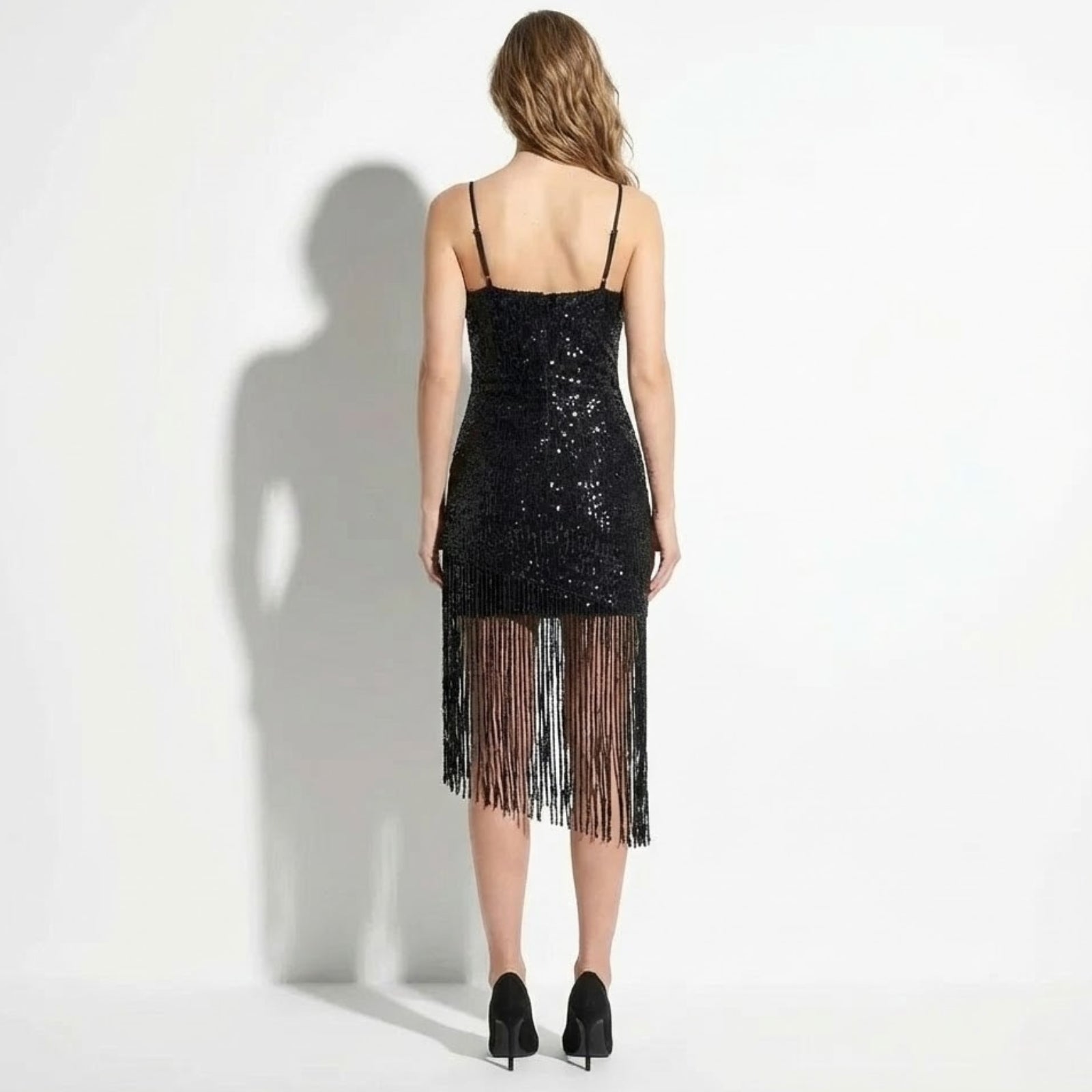 Back view of the Kouvr Fashion black sequin dress showing the open back design and spaghetti straps. 