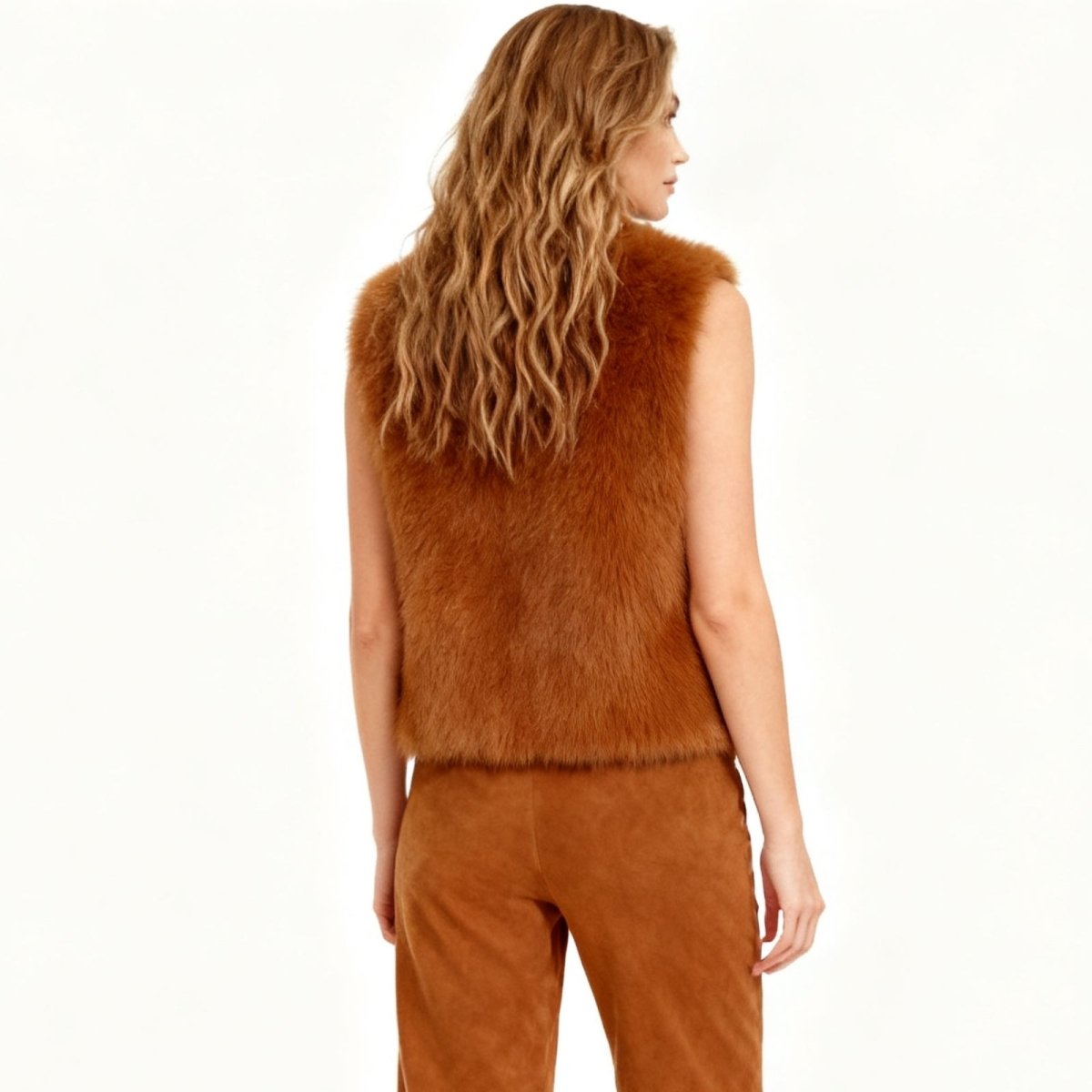 Woman wearing a brown Kouvr fur vest on a white background