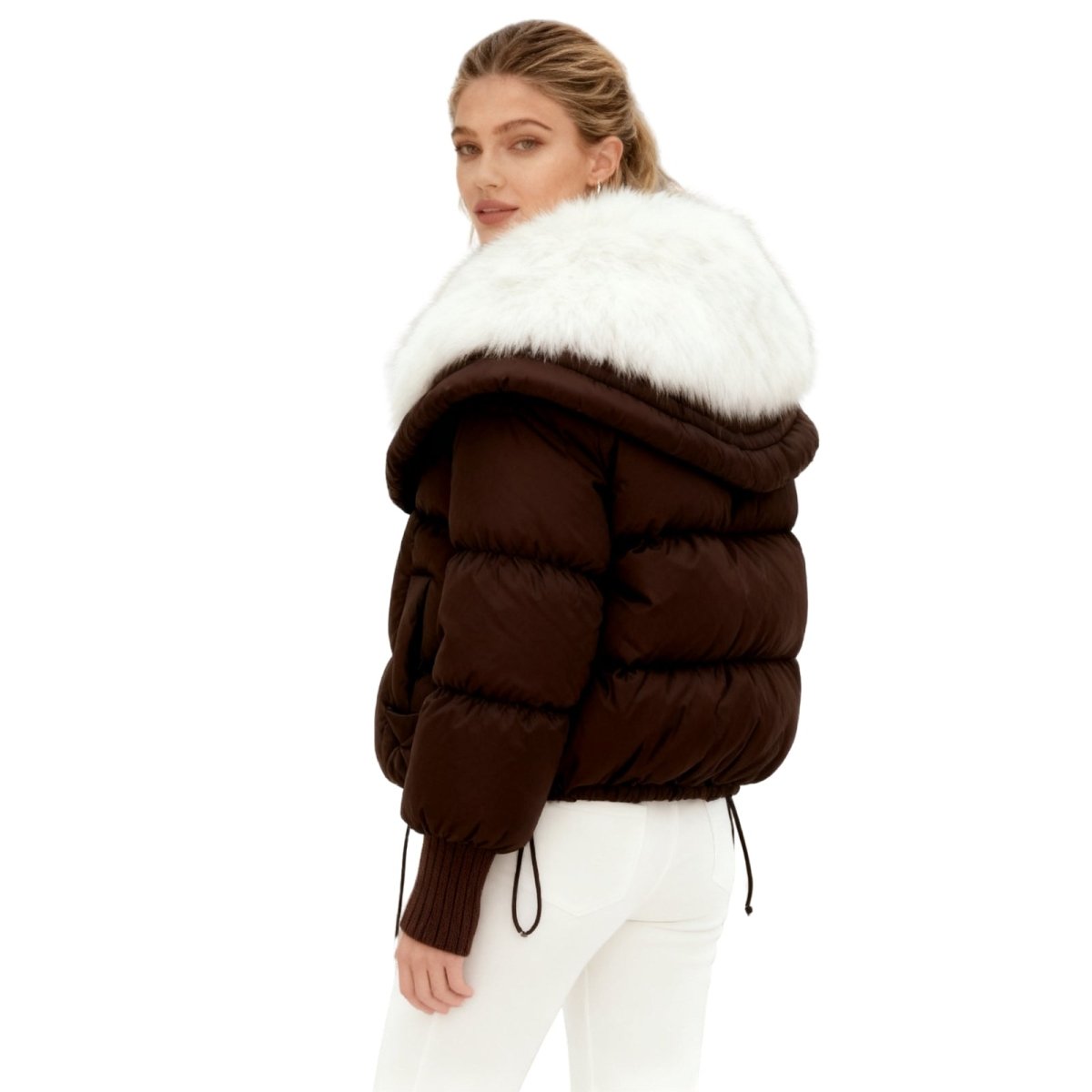 Woman wearing a brown Kouvr puffer jacket with white fur trim on a white background