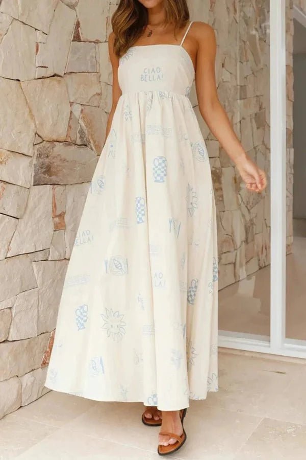 Model wearing the Kouvr Fashion Carra linen maxi dress with blue Italian print against a stone wall