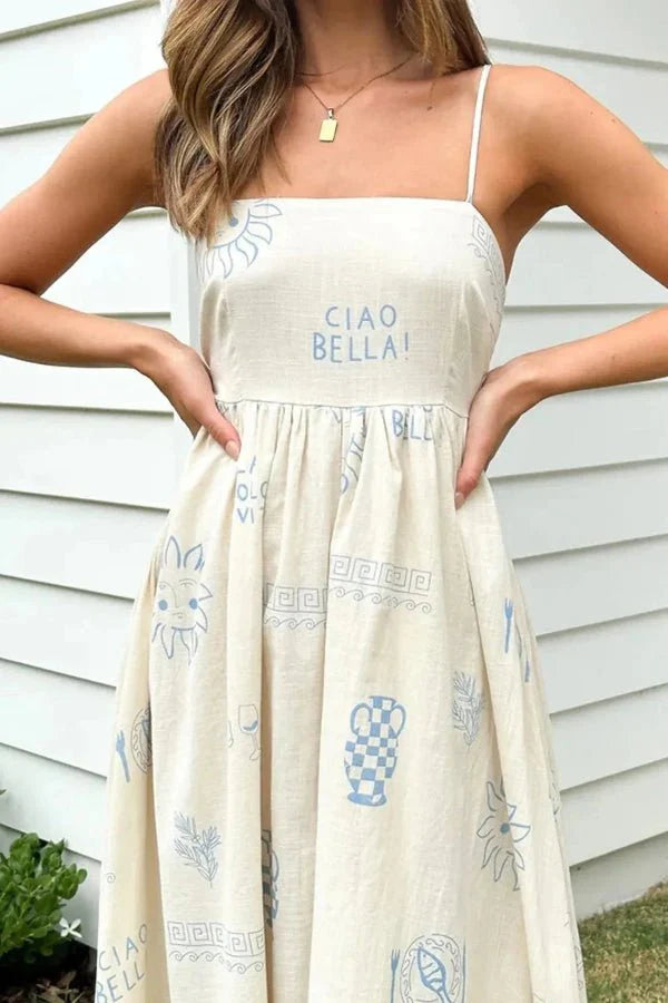 Model wearing the Kouvr Fashion Carra linen maxi dress with blue Italian print against a stone wall