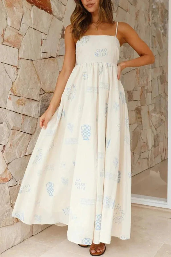 Model wearing the Kouvr Fashion Carra linen maxi dress with blue Italian print against a stone wall