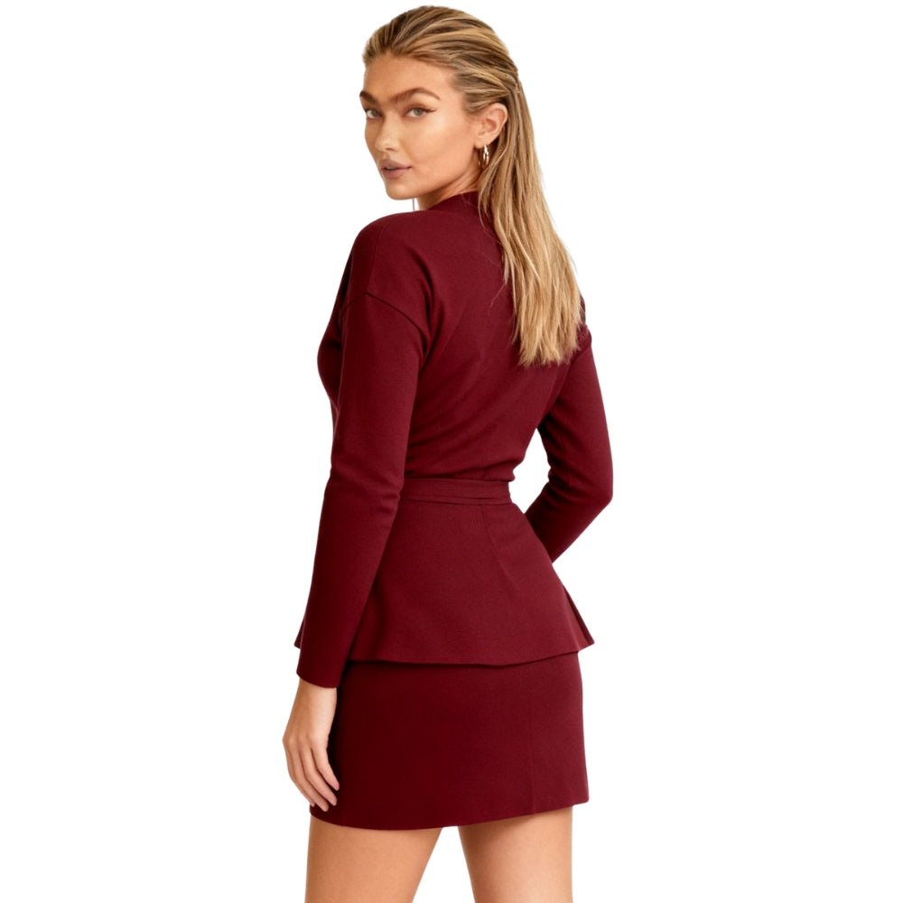 Woman wearing a Burgundy Kouvr dress with a white background