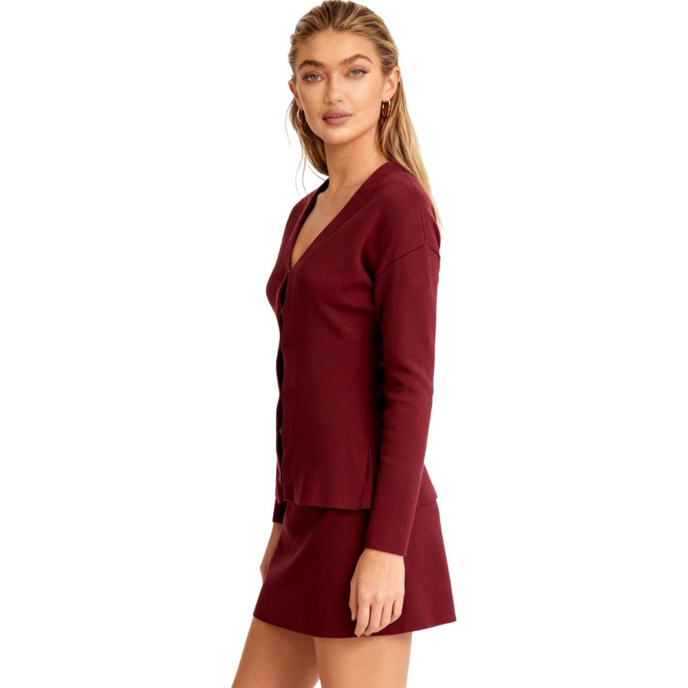 Woman wearing a Burgundy Kouvr dress with long sleeves on a white background