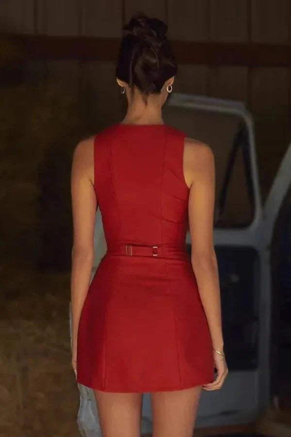 Model wearing the Kouvr Cosette sleeveless red mini dress in a rustic setting