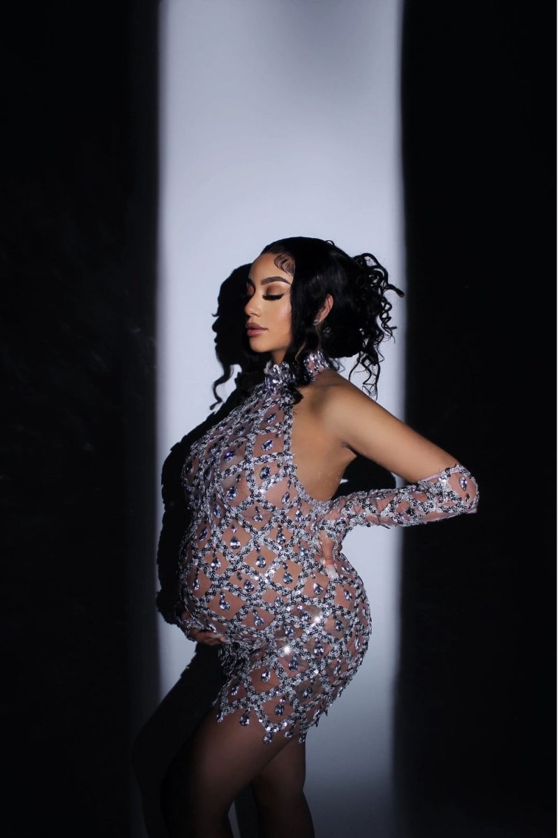 Model wearing the Kouvr Fashion silver crystal embellished sheer halter mini dress with matching long sleeves against a white background