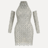 Model wearing the Kouvr Fashion silver crystal embellished sheer halter mini dress with matching long sleeves against a white background
