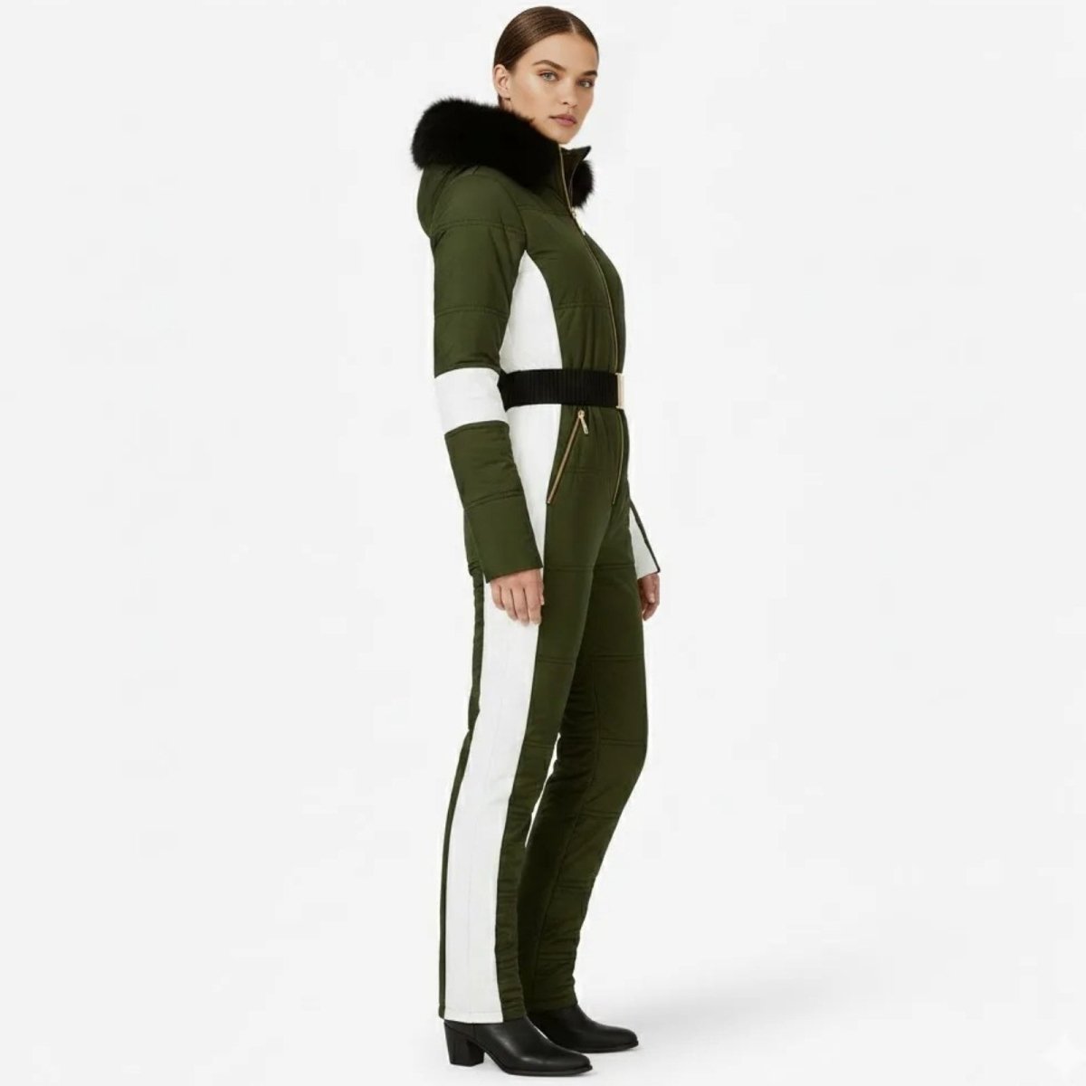 Side profile of a woman in a slim-fit olive green and white Kouvr Fashion ski jumpsuit showing the white leg stripe.
