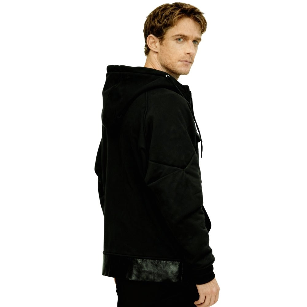 Side profile of model in the Kouvr Fashion Dominic hoodie, showing sleeve and pocket details.