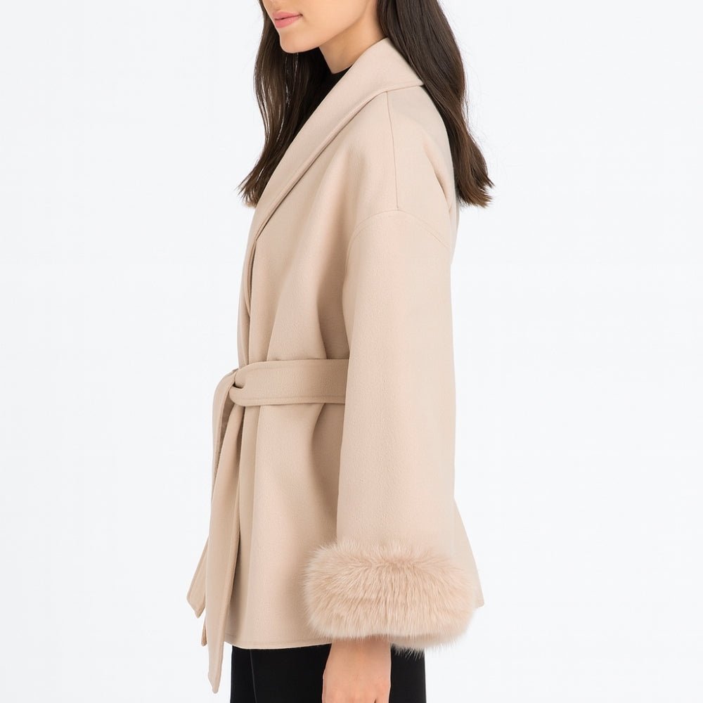 Detailed side view of the Kouvr Fashion Emma coat, focusing on the texture of the wool and the thick fox fur cuff.