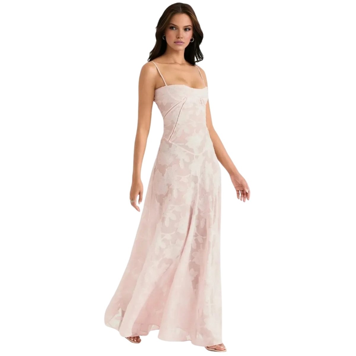 Woman wearing a long, light pink Kouvr dress on a white background