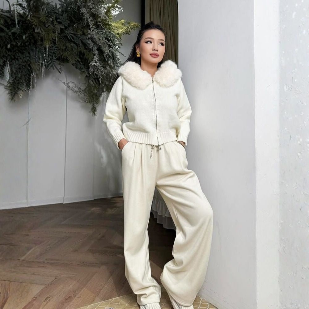 Woman wearing the Kouvr ivory knit hoodie with plush faux fur trim, styled with matching wide-leg pants