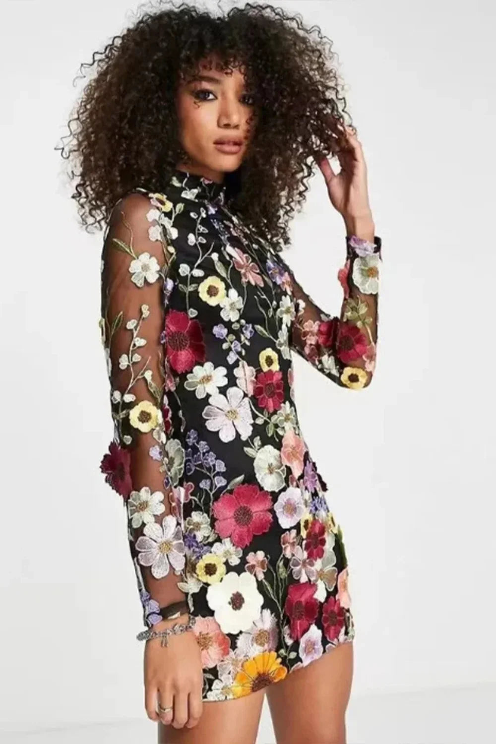 Model in Kouvr Fashion high neck black mini dress with vibrant multicolor 3D floral appliqué embroidery