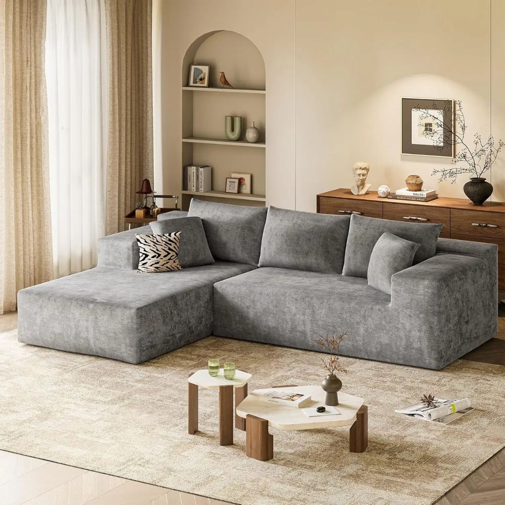Gray kouvr sectional sofa in a living room with decor elements.