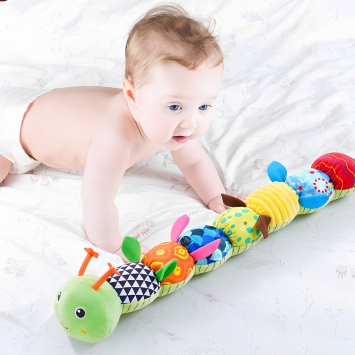 Baby doing tummy time with the colorful Melody Caterpillar sensory toy by Kouvr Fashion.