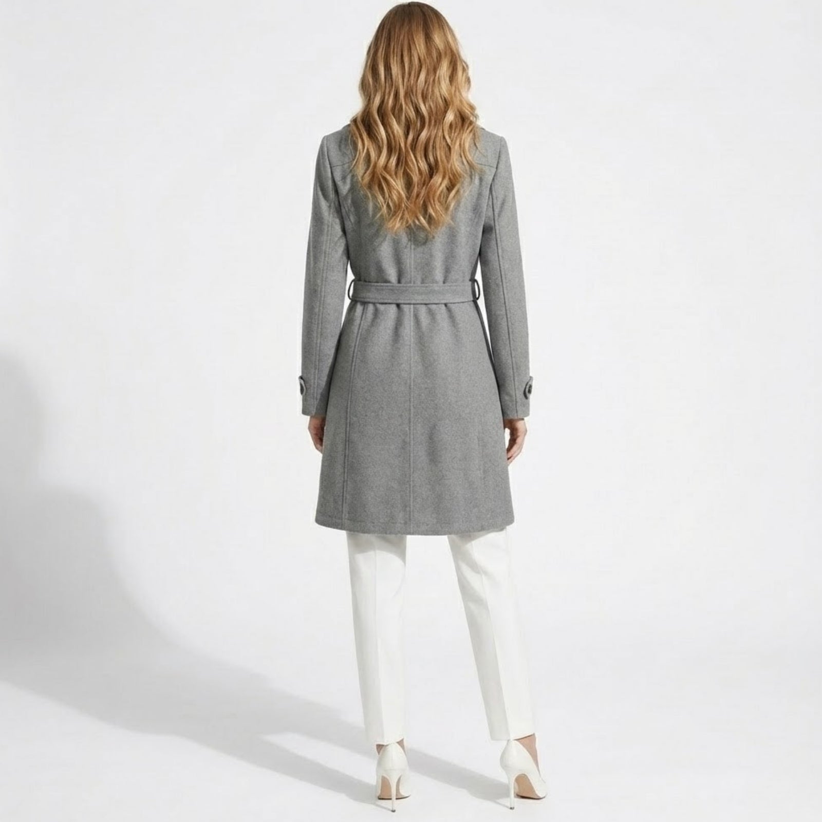 Back view of a woman wearing the Priscilla grey wool coat with the belt tied, showcasing the tailored fit and center seam detail.