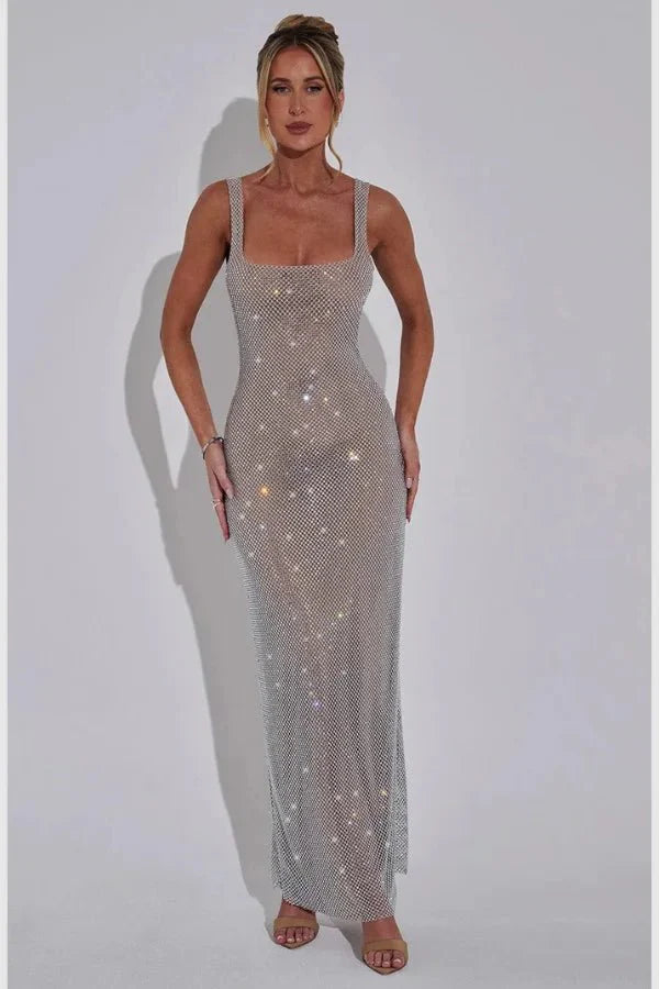 Model wearing the Kouvr Fashion Isabeu Gown, a silver floor-length rhinestone crystal mesh dress with a square neckline