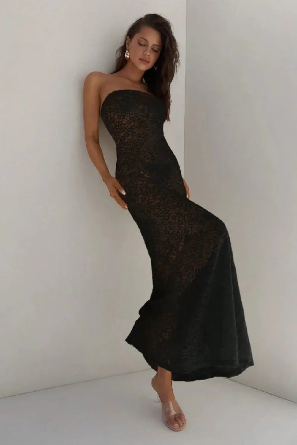 Model wearing the Mariposa black lace strapless mermaid gown by Kouvr Fashion