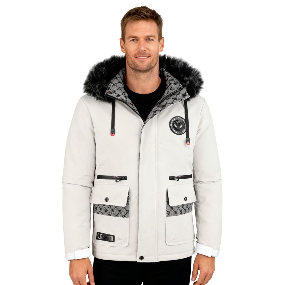 Man wearing a light gray winter jacket with fur hood on a white background