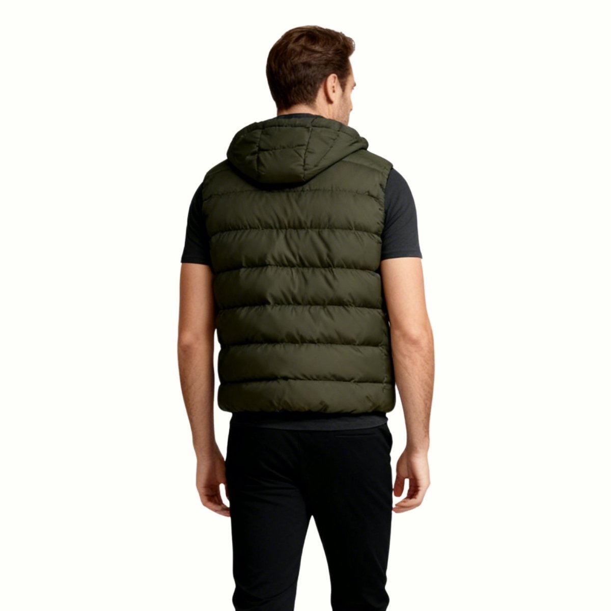 Back view of a man wearing the Kouvr Fashion army green puffer vest with the hood up.