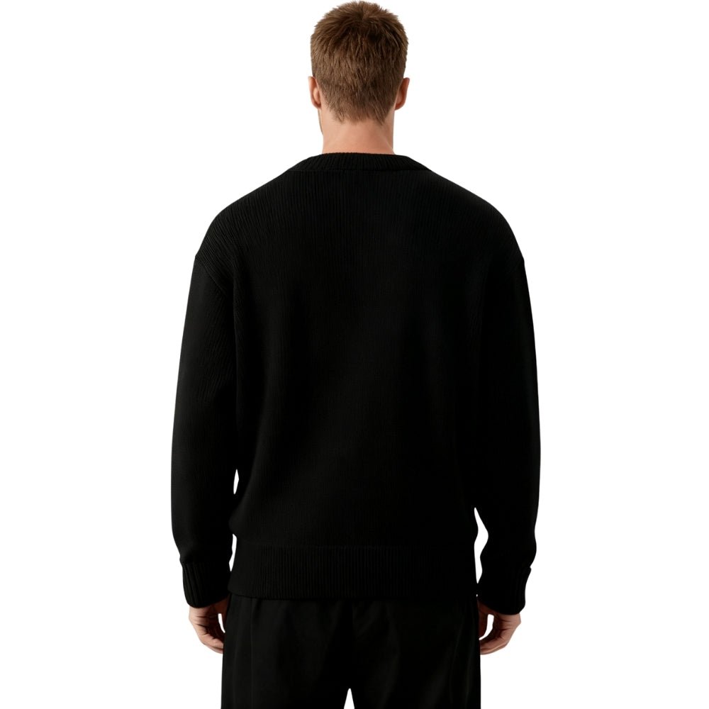 'monochrome,' 'intarsia knit,' 'geometric pattern,' 'heavyweight wool,' and 'statement piece