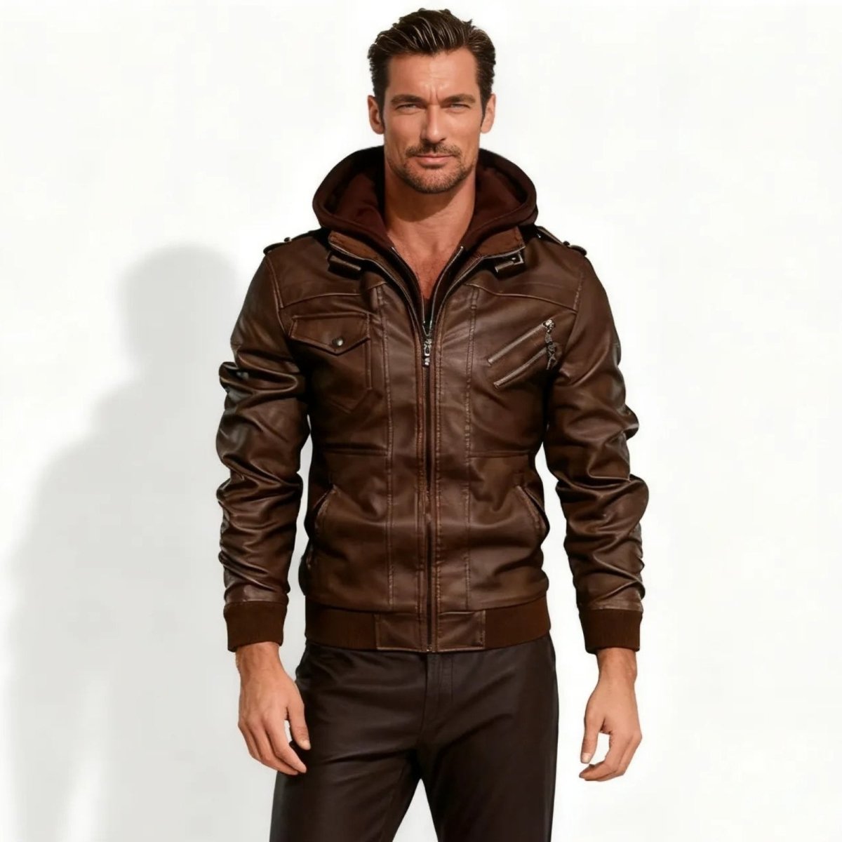 Model wearing the Kouvr Fashion men's brown faux leather hooded bomber jacket, front view against a white background.