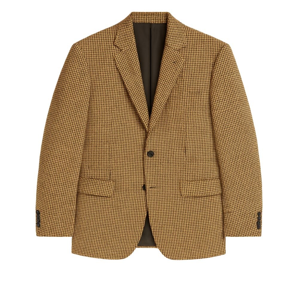 Model wearing Kouvr Fashion brown and black houndstooth blazer with black trousers