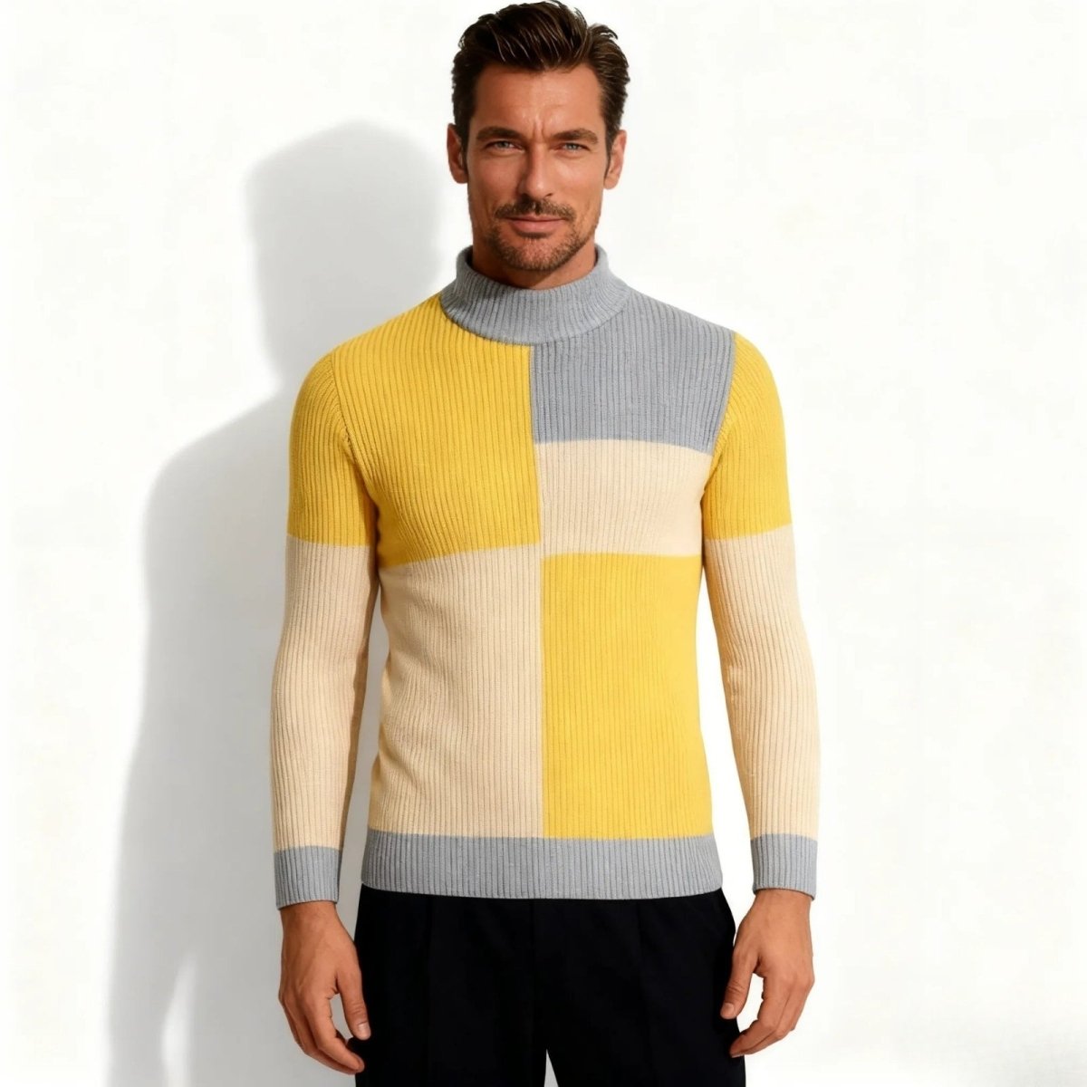Man wearing the Kouvr Fashion yellow, grey, and cream color-block turtleneck sweater, viewed from the front.