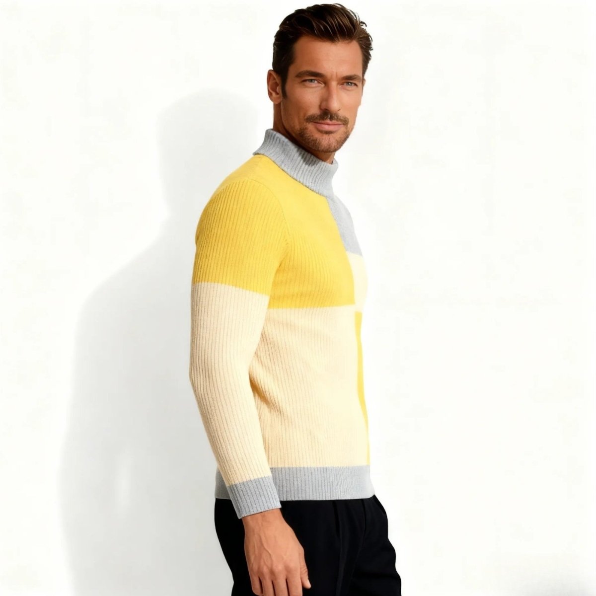 Side profile of a man in the Kouvr Fashion modern fit ribbed knit color-block sweater.