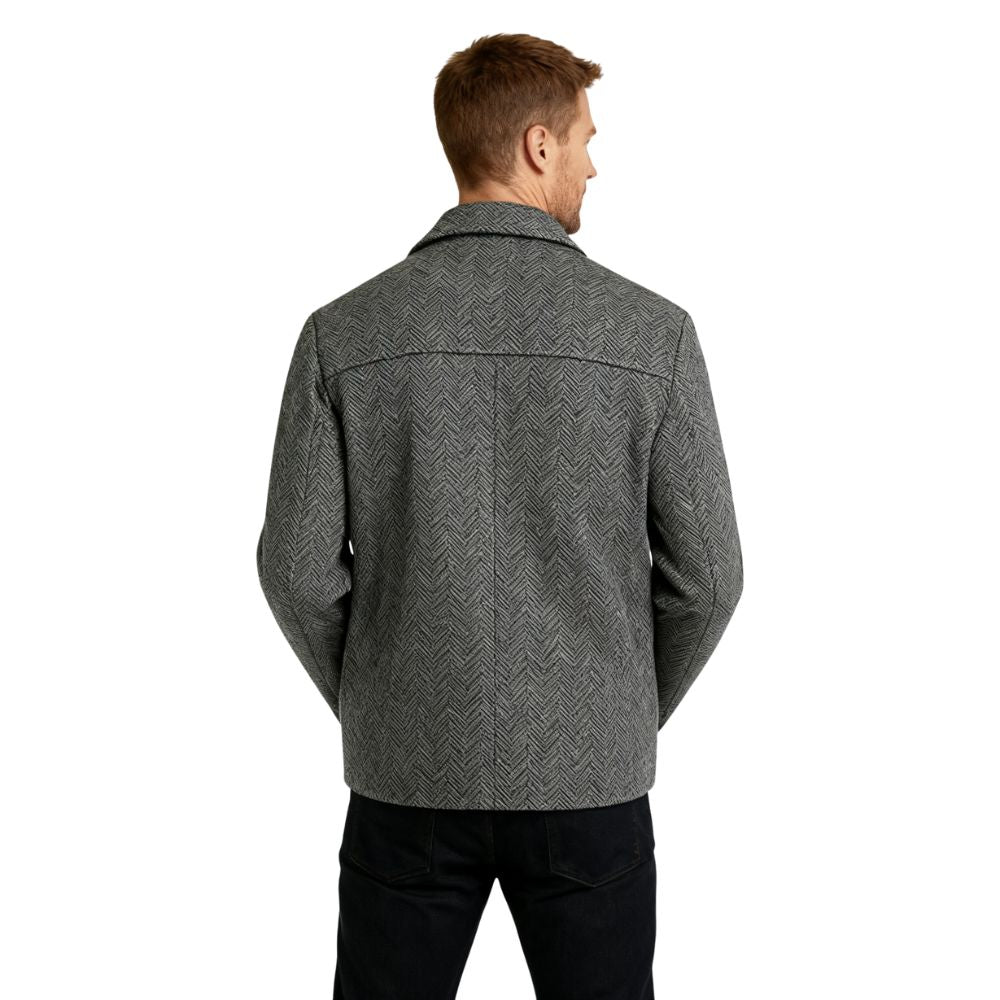 Man wearing a gray kouvr patterned jacket on a white background