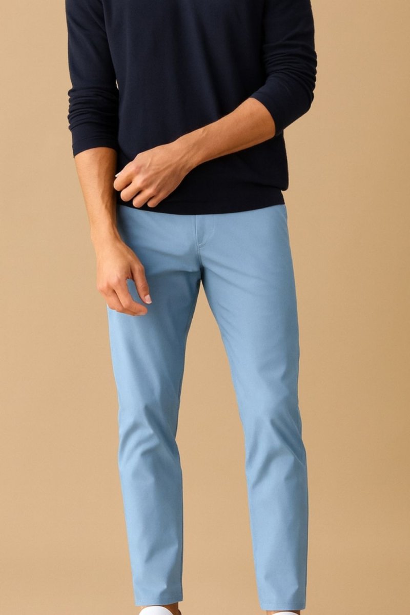 Man wearing Kouvr modern slim fit performance trousers in blue, showing clean lines and back pocket detail