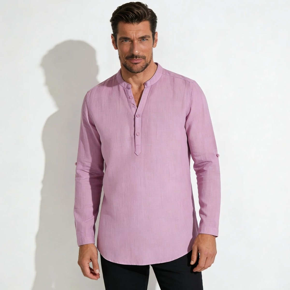 A male model with dark hair and a beard wearing the Kouvr Fashion roby pink linen-blend band collar long-sleeve shirt, looking directly at the camera.