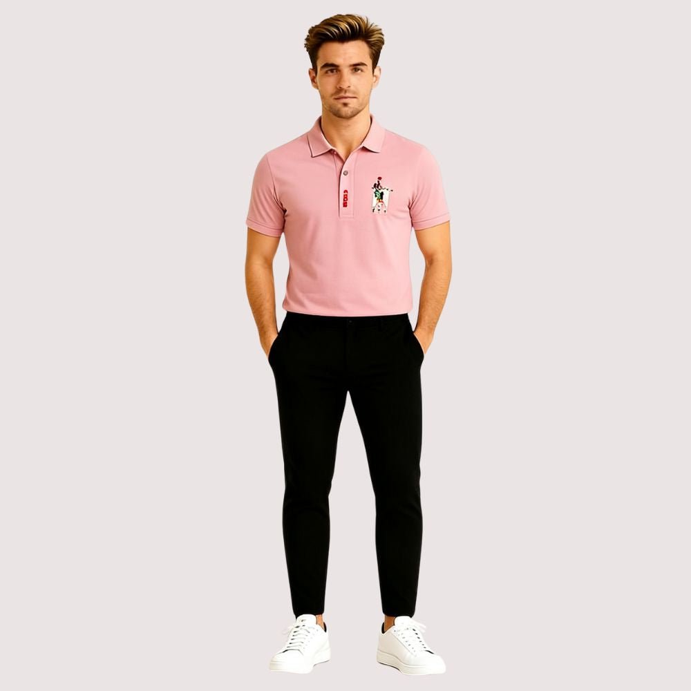Man wearing the Kouvr slim fit Rose Quartz pink polo shirt with black trousers against a white background.