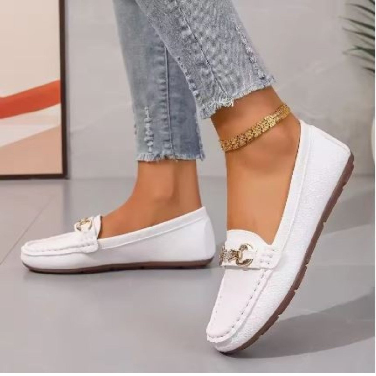 Top-down view of Kouvr Mildred women's white pebbled leather loafers with a gold jeweled horsebit buckle.