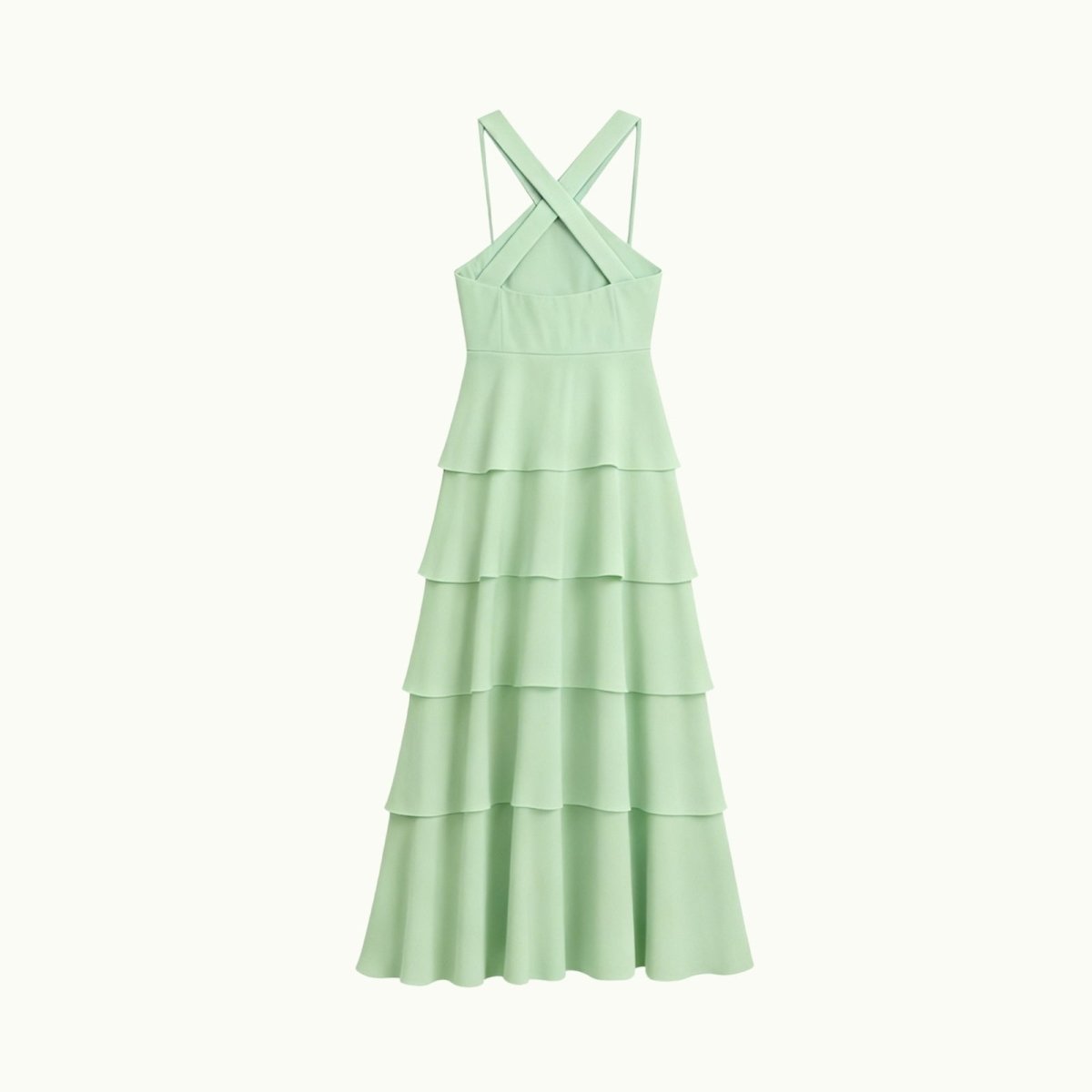 Light green Kouvr tiered dress with criss-cross straps on a white background