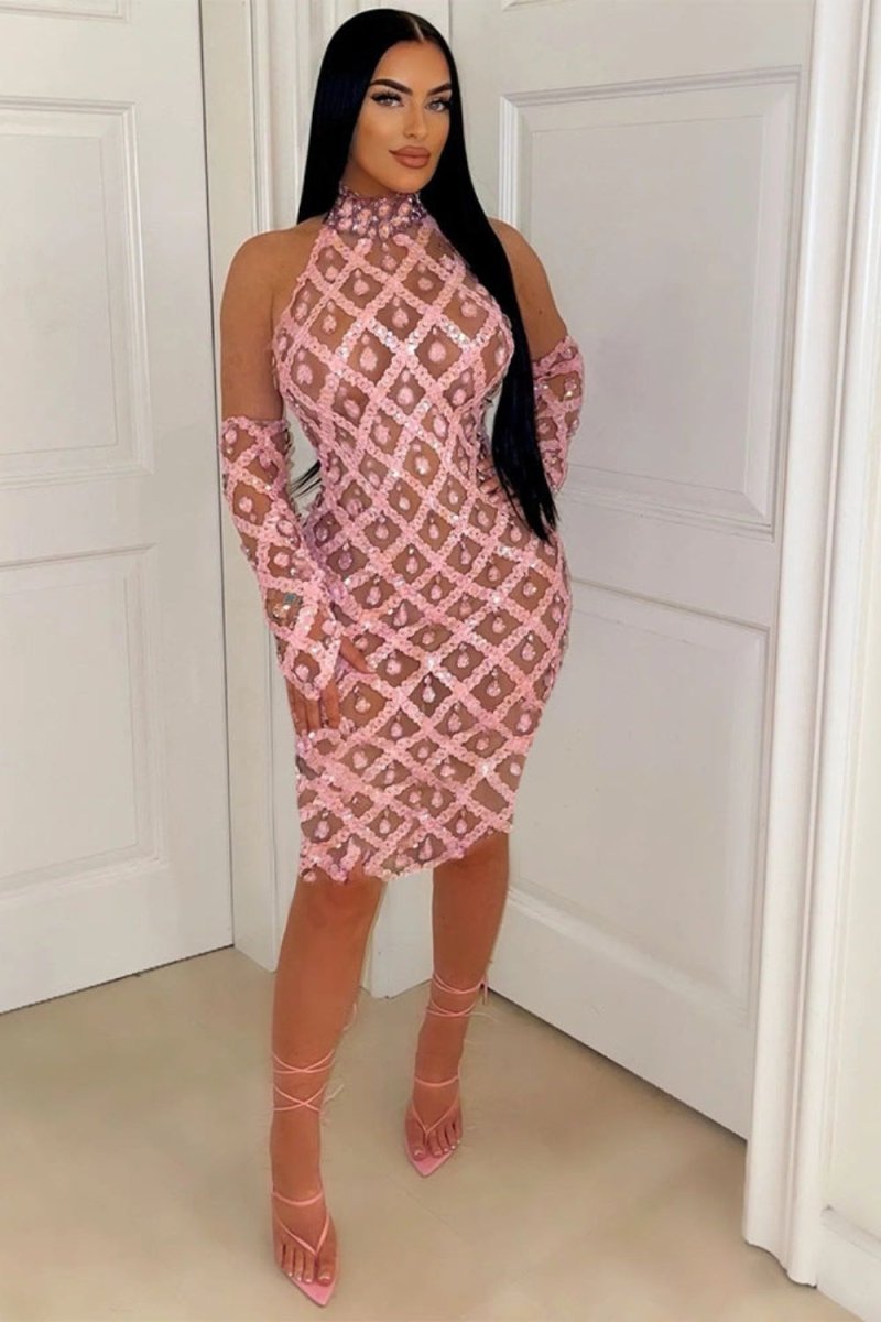 A woman wearing the Kouvr Fashion Myra Pink Sequin Halter Neck Bodycon Dress with matching long gloves, standing indoors