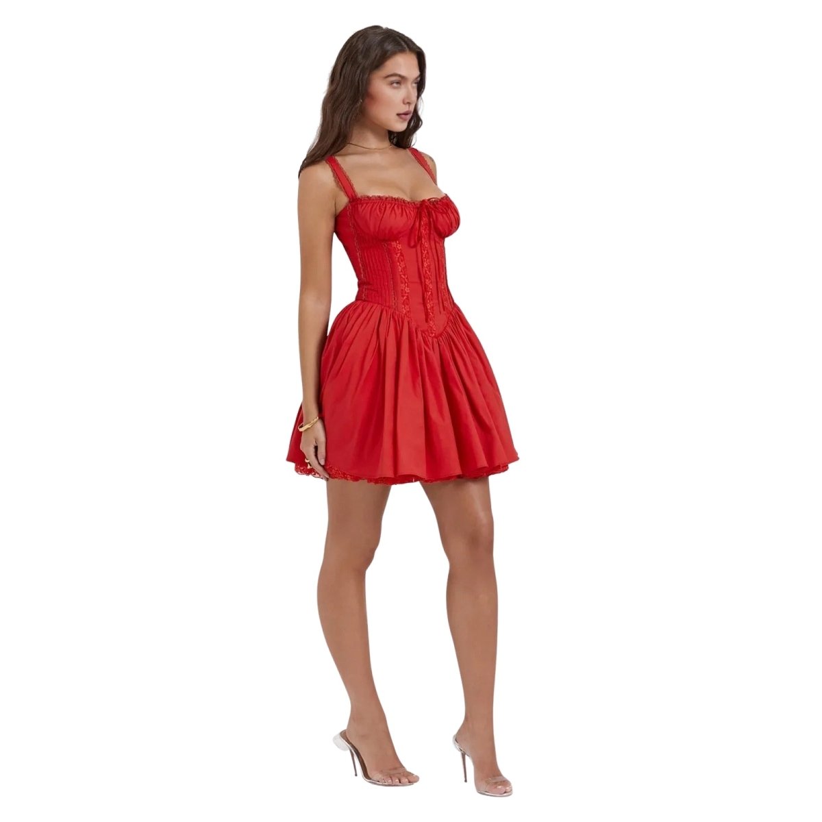Side view of a woman in a red kouvr A-line corset mini dress with high heels.