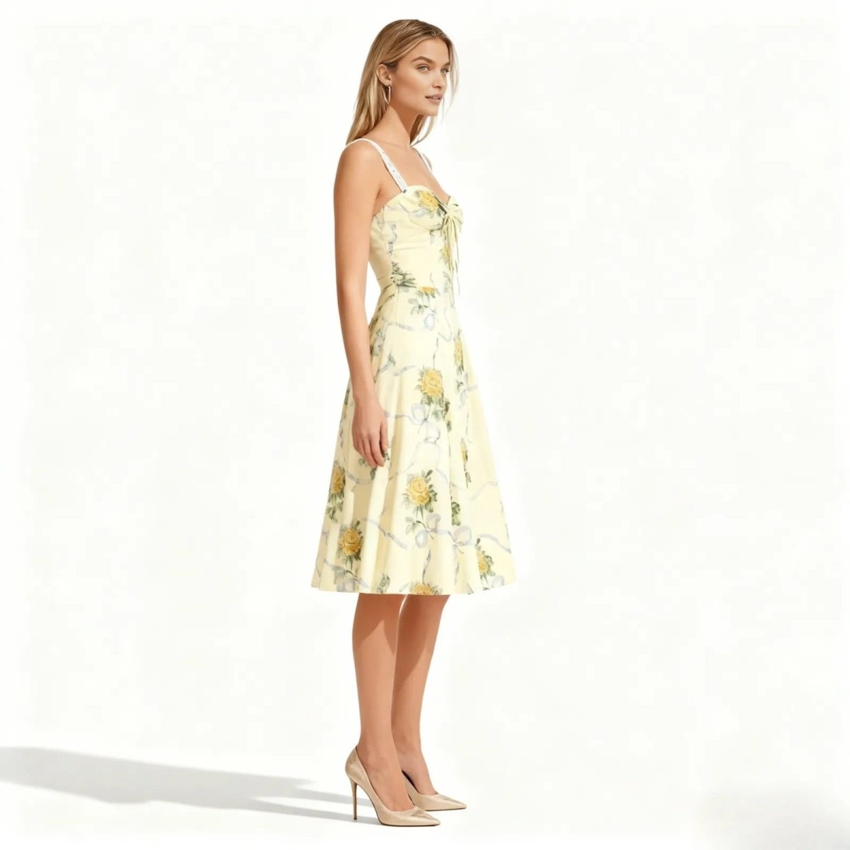 Woman wearing a light yellow floral dress on a white background