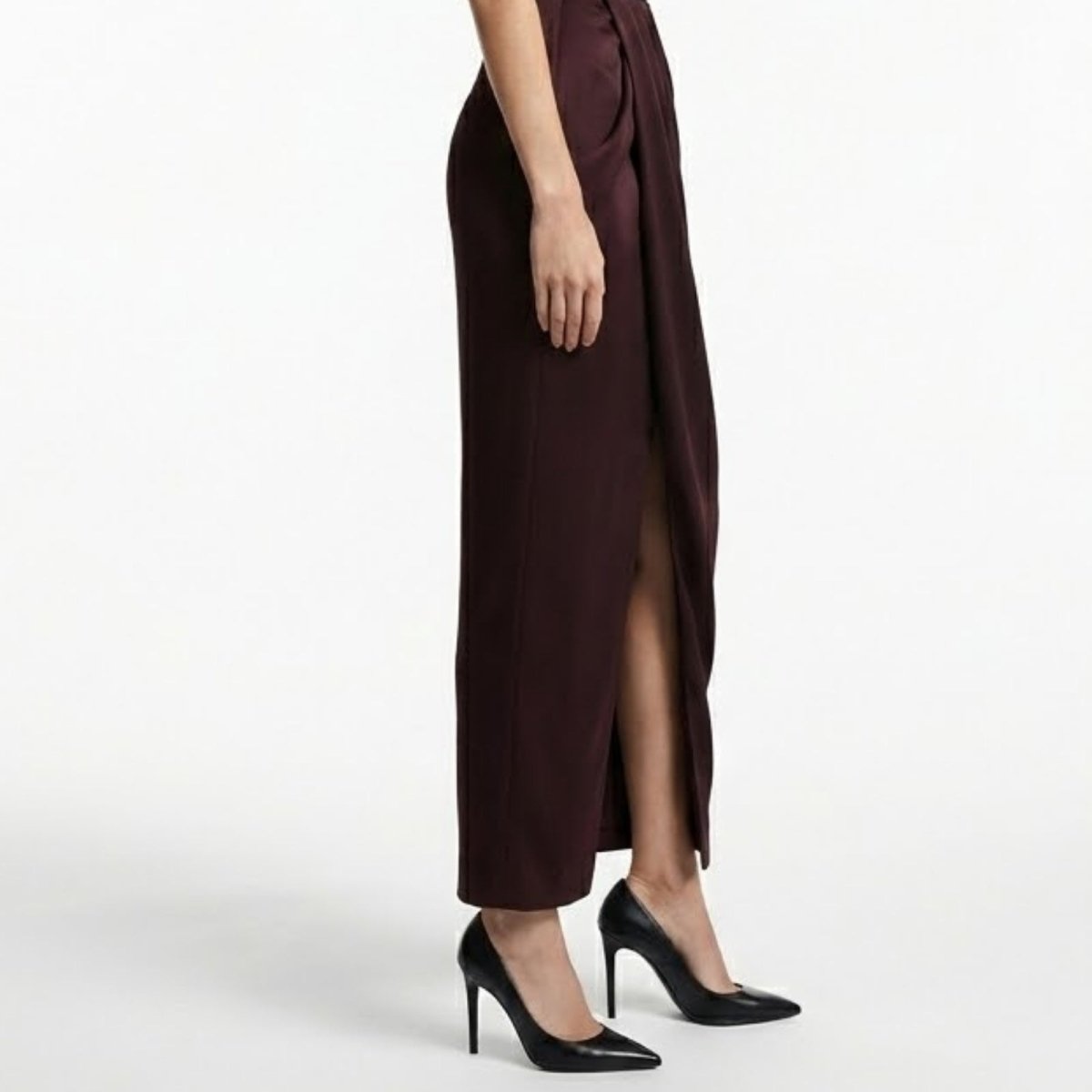 Close-up detail of the luxurious satin fabric and elegant front leg slit on the Kouvr Fashion Theia draped pant.