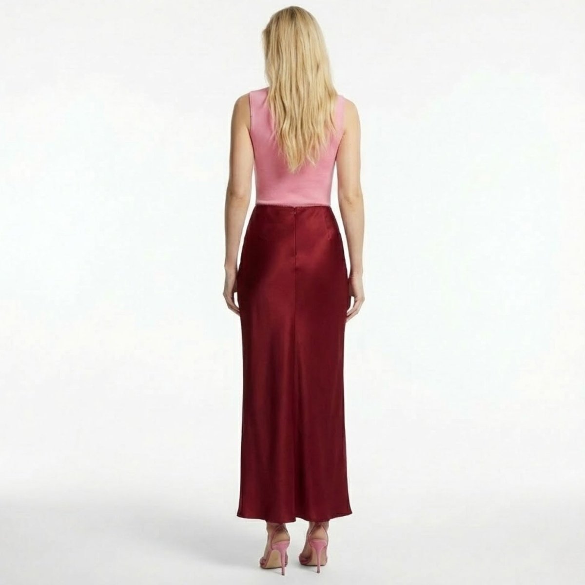 Back view of The Ourania red satin maxi skirt by Kouvr Fashion, highlighting the seamless construction.