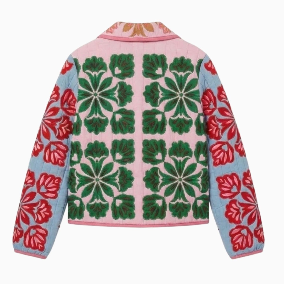 Flat lay showing the back of a quilted jacket with a repeating green floral tile pattern on a pink background and blue embroidered sleeves.