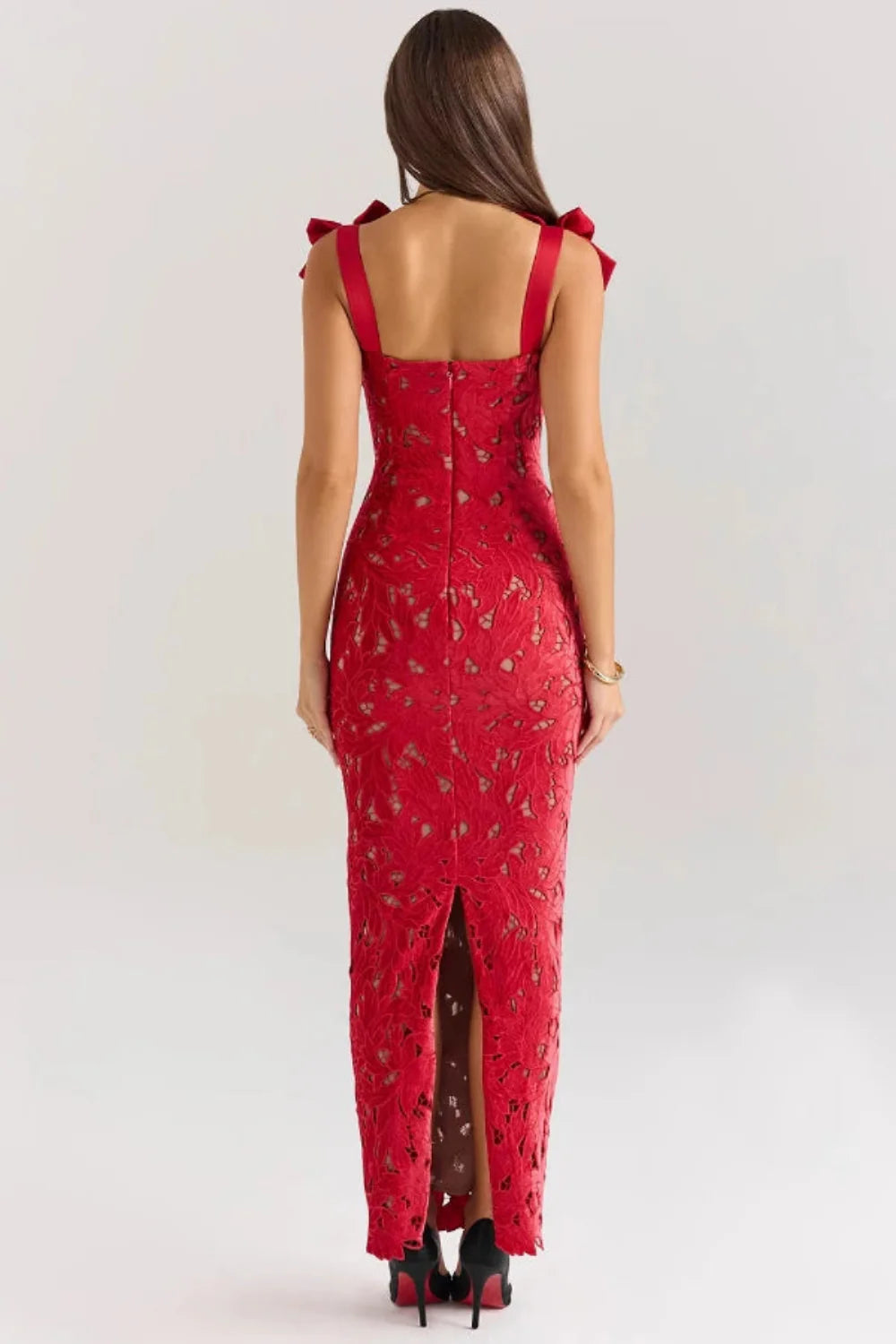 Back view of the Kouvr Fashion Penelope lace gown showing the rear slit and bow strap detail
